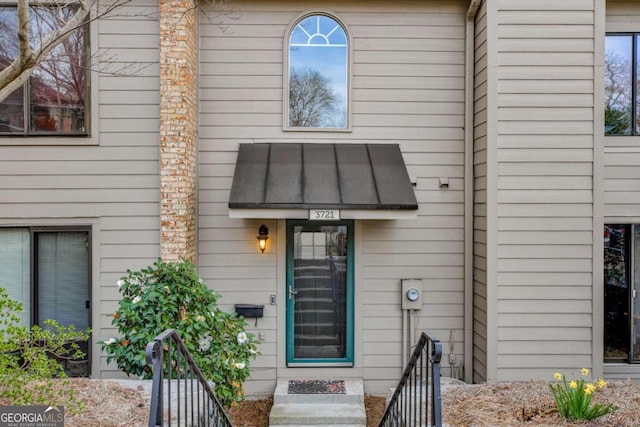 doorway to property featuring a standing seam roof and metal roof