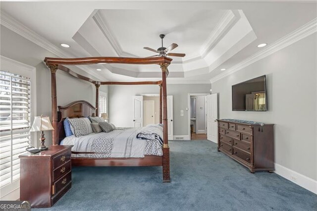 carpeted bedroom with baseboards, ceiling fan, a tray ceiling, crown molding, and recessed lighting