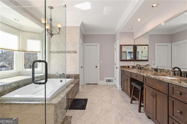 bathroom featuring ornamental molding, a sink, and visible vents