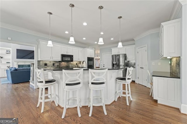 kitchen featuring dark countertops, black microwave, white cabinets, and stainless steel fridge with ice dispenser