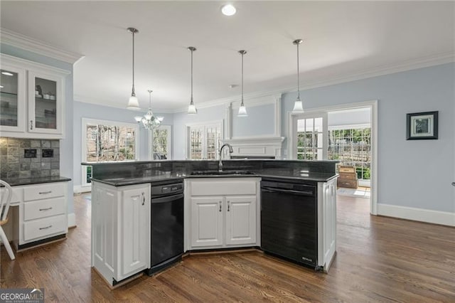 kitchen with black dishwasher, dark wood-style flooring, crown molding, dark countertops, and a sink