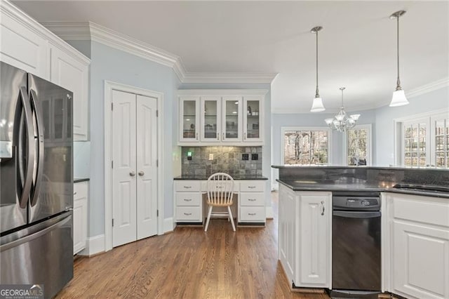 kitchen with white cabinetry, stainless steel fridge with ice dispenser, tasteful backsplash, dark countertops, and crown molding