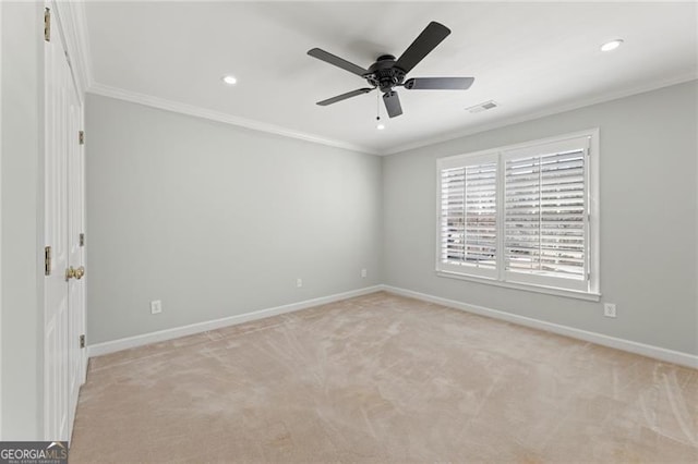 unfurnished room with baseboards, visible vents, and crown molding