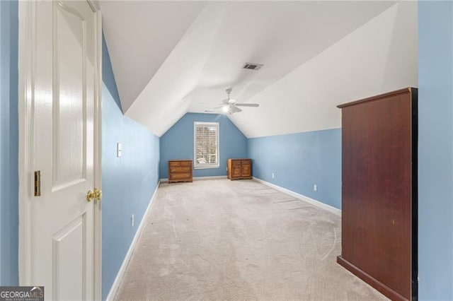 additional living space featuring carpet floors, visible vents, vaulted ceiling, and baseboards