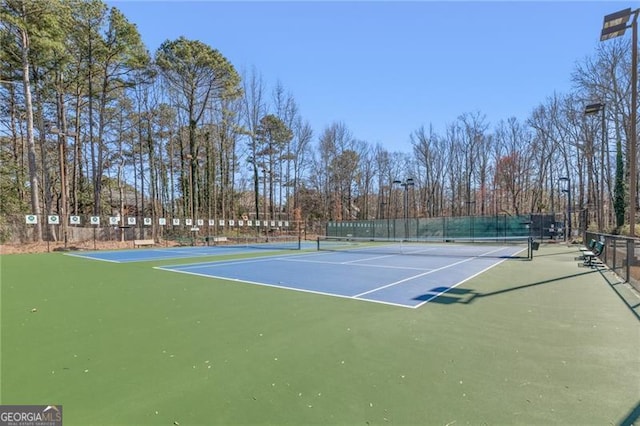 view of sport court with fence