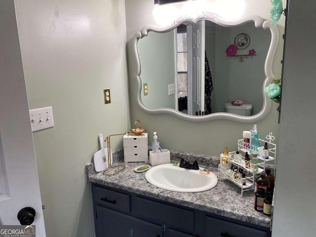 bathroom featuring vanity and toilet