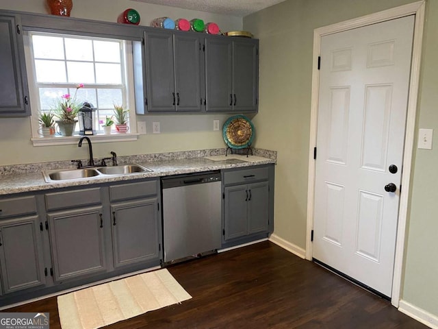 kitchen featuring a sink, gray cabinets, dishwasher, and light countertops