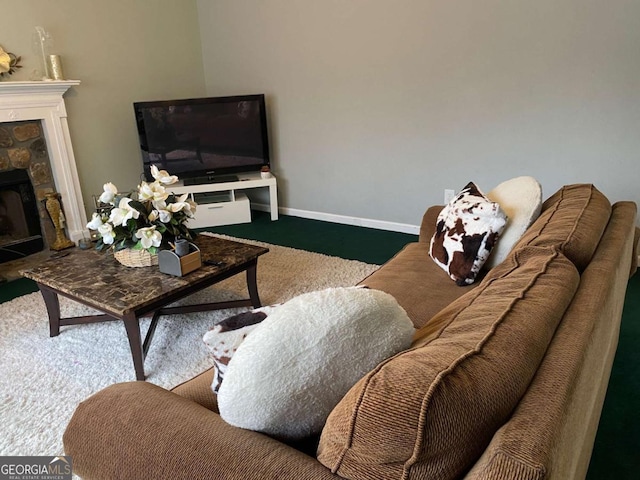 living area featuring a fireplace and baseboards