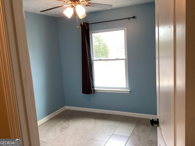 1141 N Clark St, Milledgeville, GA 31061 - spare room with ceiling fan, baseboards, and a textured ceiling