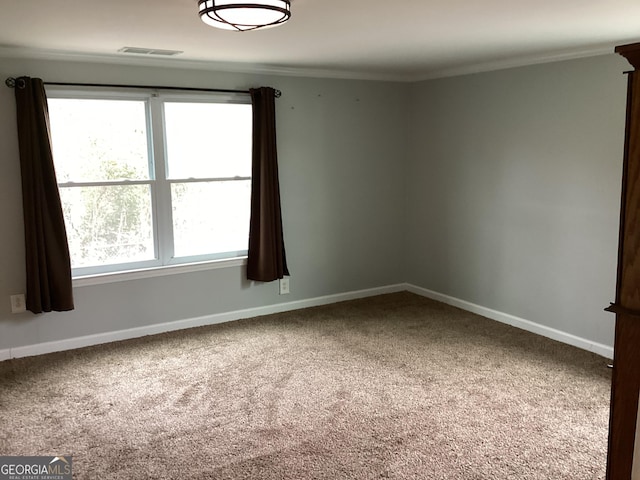 1141 N Clark St, Milledgeville, GA 31061 - carpeted empty room with visible vents, baseboards, and crown molding