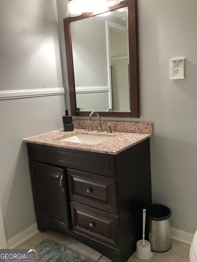 1141 N Clark St, Milledgeville, GA 31061 - half bathroom with tile patterned flooring, vanity, and baseboards