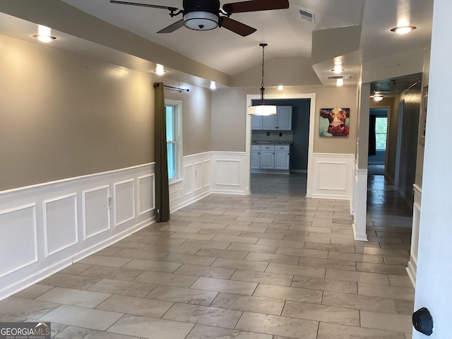 1141 N Clark St, Milledgeville, GA 31061 - spare room featuring a decorative wall, visible vents, a ceiling fan, vaulted ceiling, and wainscoting