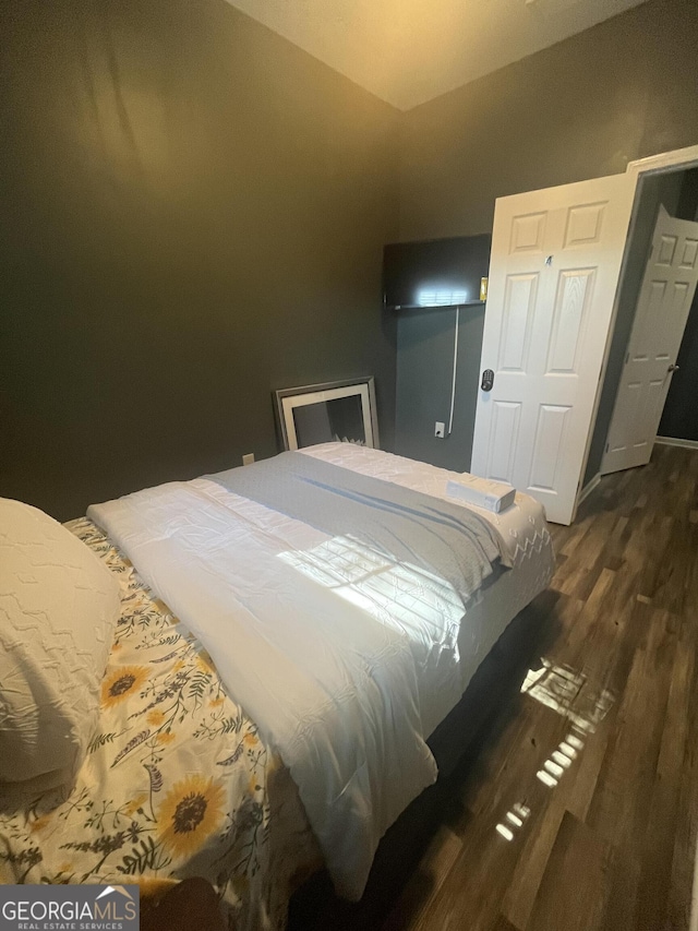 bedroom with dark wood finished floors