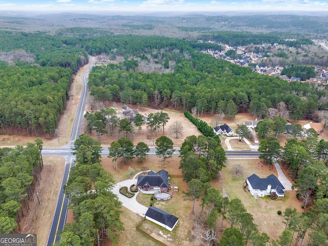 drone / aerial view featuring a view of trees