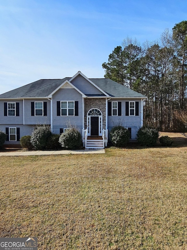 bi-level home with a front lawn