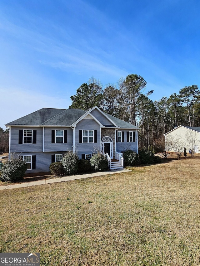 raised ranch with a front lawn