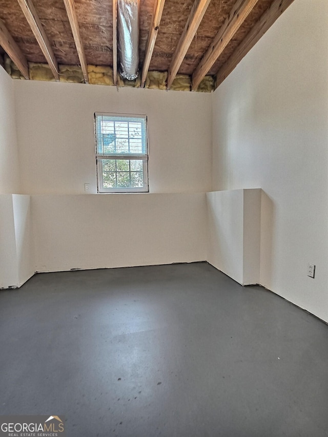 unfurnished room with finished concrete flooring