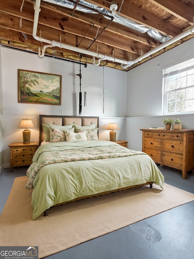 bedroom featuring finished concrete floors