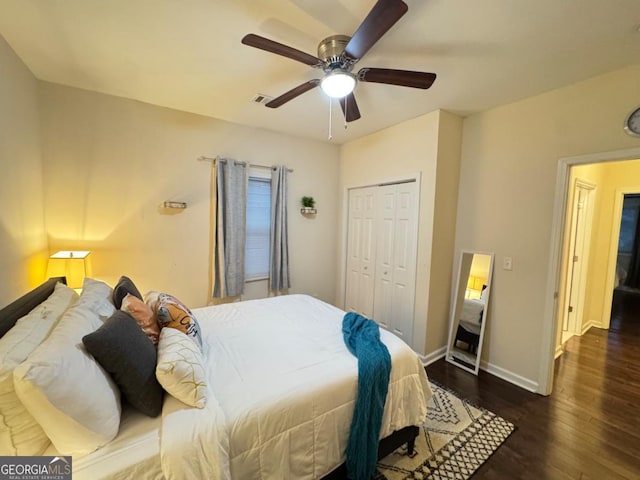 bedroom with a closet, visible vents, ceiling fan, wood finished floors, and baseboards