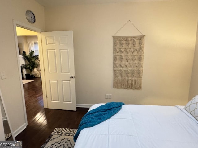 bedroom featuring dark wood-type flooring and baseboards