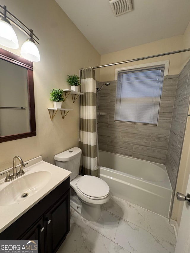 bathroom featuring vanity, toilet, visible vents, shower / bath combo with shower curtain, and marble finish floor