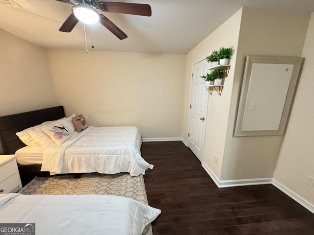 bedroom with ceiling fan, wood finished floors, and baseboards