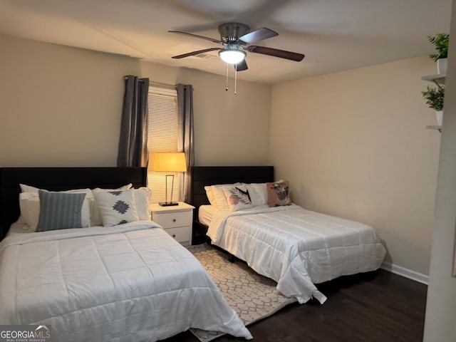 bedroom with ceiling fan, wood finished floors, and baseboards