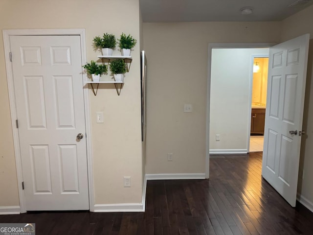 unfurnished bedroom featuring dark wood finished floors and baseboards