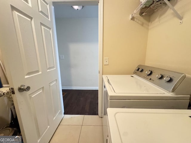 laundry area featuring laundry area, independent washer and dryer, baseboards, and tile patterned floors