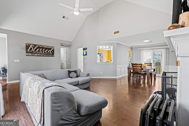 living area with dark wood-type flooring, visible vents, and a ceiling fan