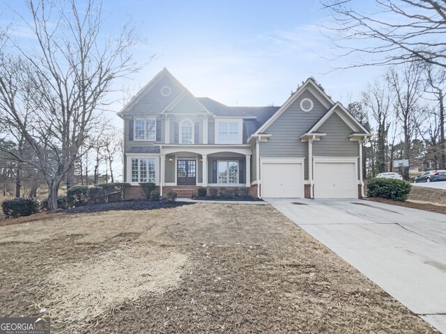 view of front of property featuring a garage, concrete driveway, and brick siding