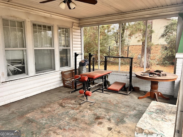 sunroom with wood ceiling and a ceiling fan