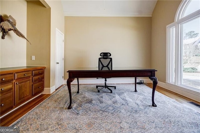 office space with baseboards, dark wood-type flooring, and ornamental molding