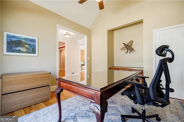 office area with vaulted ceiling, ceiling fan, ornamental molding, and light wood-style flooring