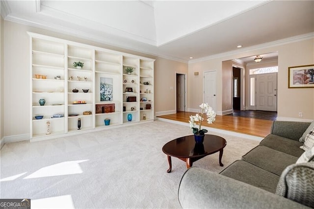 living area with crown molding, baseboards, and wood finished floors