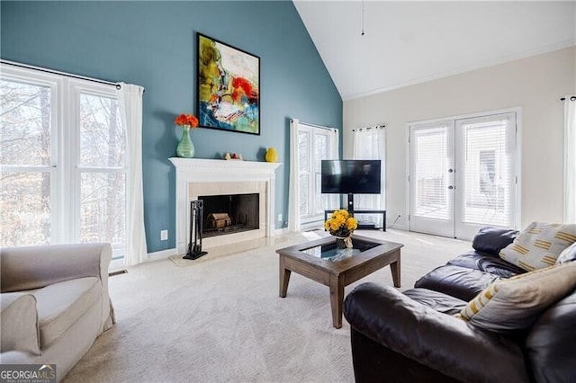 living area with baseboards, carpet flooring, french doors, high vaulted ceiling, and a high end fireplace