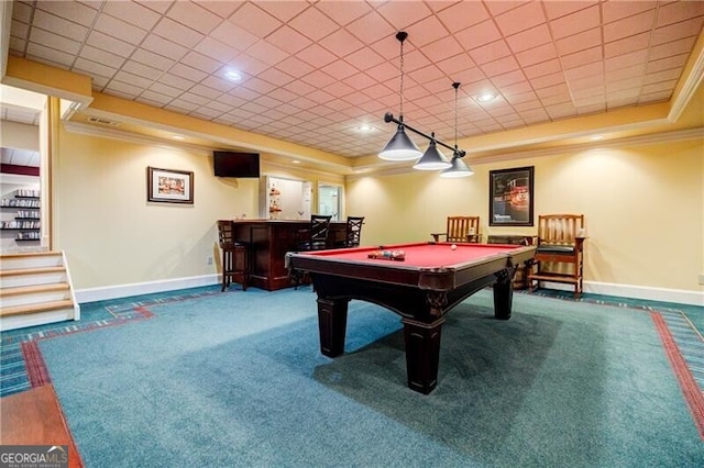 game room with baseboards, a bar, ornamental molding, a tray ceiling, and carpet floors