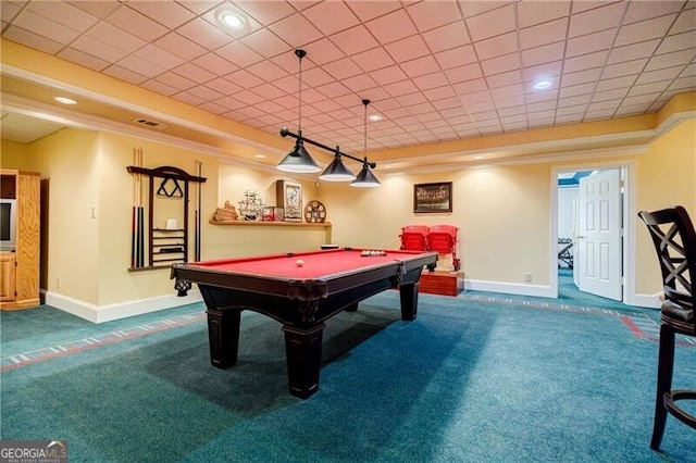 rec room with ornamental molding, a tray ceiling, carpet, and baseboards