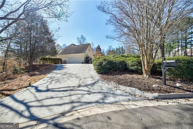 view of property exterior with driveway and an attached garage