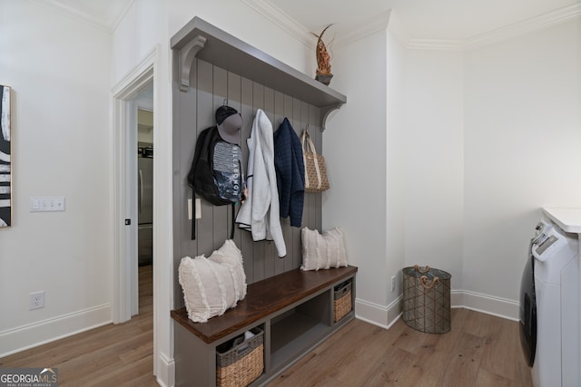 mudroom featuring ornamental molding, washer / clothes dryer, and wood finished floors