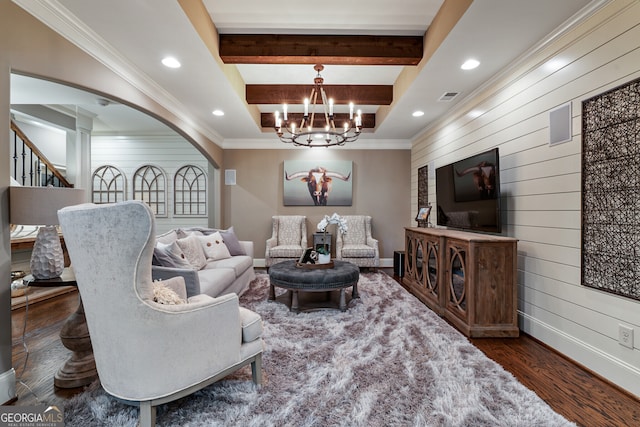 living room with wood walls, visible vents, stairs, beam ceiling, and dark wood finished floors