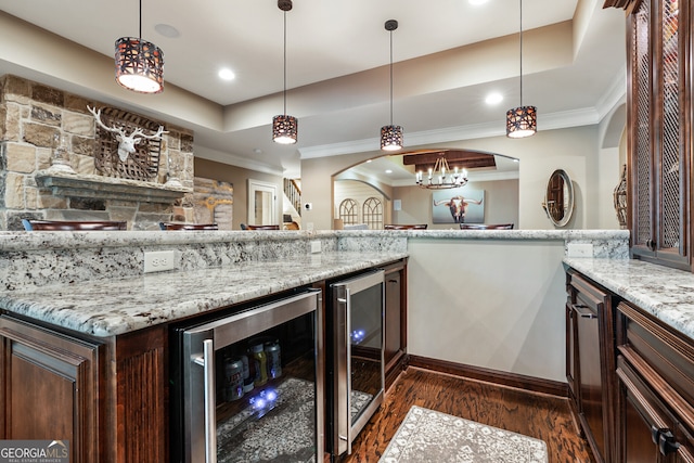 kitchen featuring a tray ceiling, wine cooler, and dark wood-type flooring