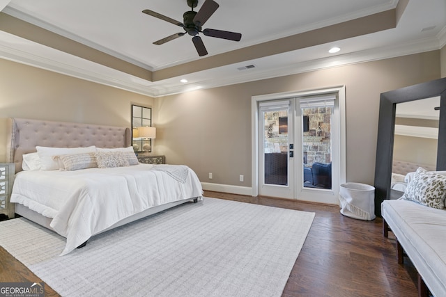 bedroom with dark wood-style floors, a tray ceiling, access to exterior, ornamental molding, and baseboards