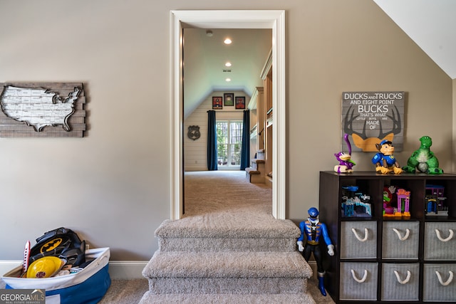 interior space with carpet floors, lofted ceiling, baseboards, and recessed lighting