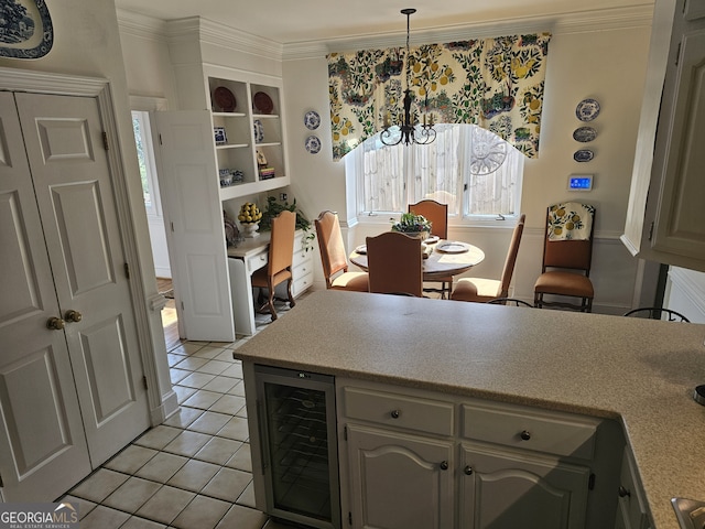 kitchen with beverage cooler, ornamental molding, gray cabinets, light countertops, and pendant lighting