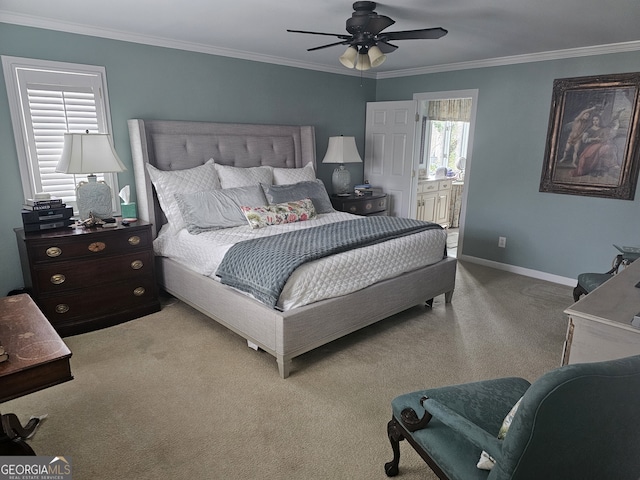 bedroom featuring light carpet, crown molding, ensuite bath, and baseboards