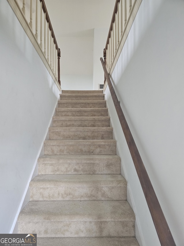 stairway featuring baseboards