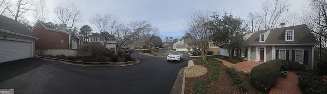 view of street with a residential view and curbs