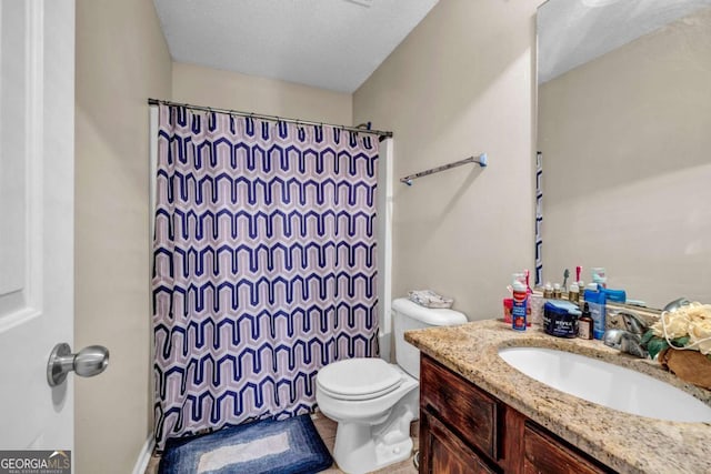 full bath with curtained shower, vanity, toilet, and a textured ceiling