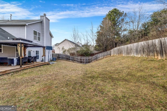 view of yard with cooling unit, a fenced backyard, a wooden deck, and a gazebo